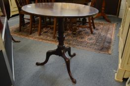 A George III mahogany circular tilt-top tripod table.
