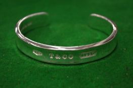 Tiffany & Co, a silver bangle, boxed.