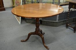A George III mahogany circular tilt-top tripod table.