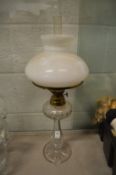 A cut glass oil lamp.