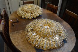 A pair of highly ornate circular two tier ceiling lights.