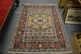 A Persian style beige ground rug with geometric decoration 180cm x 135cm.