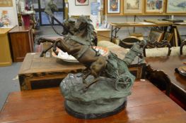 An impressive patinated cast bronze model of a Roman soldier being pulled on a chariot by two