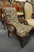 A small mahogany framed and upholstered nursing chair.