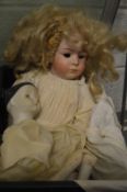 A porcelain headed doll (faults) together with another doll.