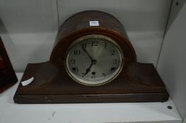 A mahogany mantel clock.