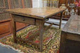 An early oak refectory dining table with a drawer to one end.