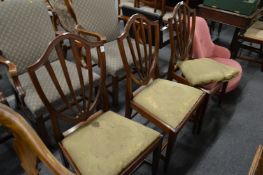 A set of three mahogany shield back dining chairs.