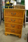 A small yew wood four drawer chest.