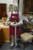 A reproduction suit of armour complete with sword.