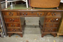 A reproduction pedestal desk.