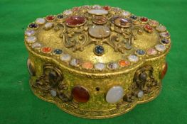 A good Continental gilt metal jewellery casket set with numerous agate, jade and other stones.