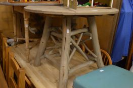 A rustic painted oak circular table.