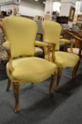 A pair of French style gilt framed open armchairs.