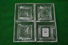 Four small glass dishes.