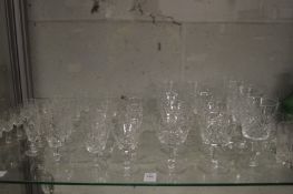 A quantity of cut glass drinking glasses, some signed.