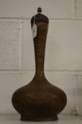 A 19th century Indian copper bottle and cover with engraved decoration.