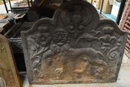 A cast iron fireback.