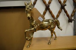 A large brass model of a horse.