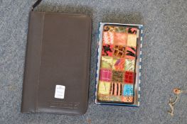 A Dispel colourful purse, boxed and a leather folder.