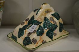 A Devon pottery cheese dish and cover.