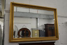 A gilt framed mirror.