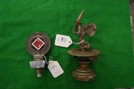 An unusual cast metal car mascot modelled as a witch with a revolving numbered base together with an