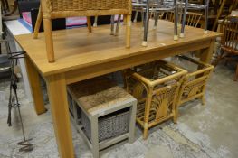 A modern light oak dining table.