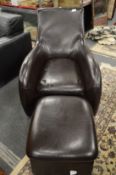 A dark brown leather cloth armchair with foot stool.