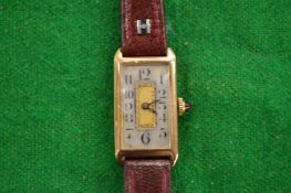 A ladies 9ct gold art deco wrist watch with leather strap.