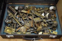 A case containing brass door furniture etc.