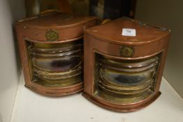 A pair of miniature copper ships lanterns.