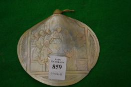 A carved mother of pearl shell.