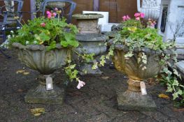 A good pair of composite garden pedestal urns complete with plants.