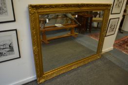 A large modern gilt framed mirror.