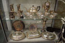 A good collection of plated items to include a set of four candlesticks, three entree dishes with