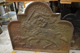 A large cast iron fireback.