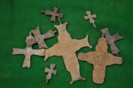 A group of bronze crosses.