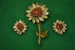 Decorative flower brooch and matching earrings signed Weiss.