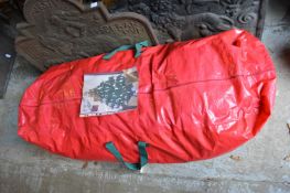 An artificial christmas tree approximately 9ft tall by 4ft wide.