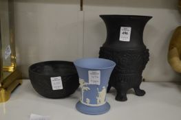 A black basalt Wedgwood vase, similar bowl and a blue jasperware beaker vase.