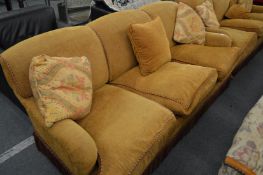 George Smith Limited, a three seater settee upholstered in a gold chenille fabric.