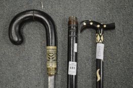 An Indian ebony sword stick together with a walking stick.