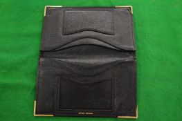 An Asprey black leather wallet.