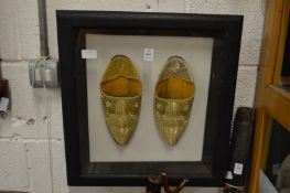 A pair of Eastern embroidered shoes framed and glazed.