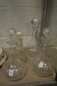 A pair of cut glass decanters and two others.