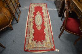 A Chinese red ground runner 215cm x 70cm.