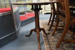 A George III mahogany tilt-top circular bird cage tripod table.