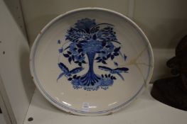 A large circular delft tin glaze blue and white dish (restored).