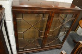 A mahogany two door display cabinet.